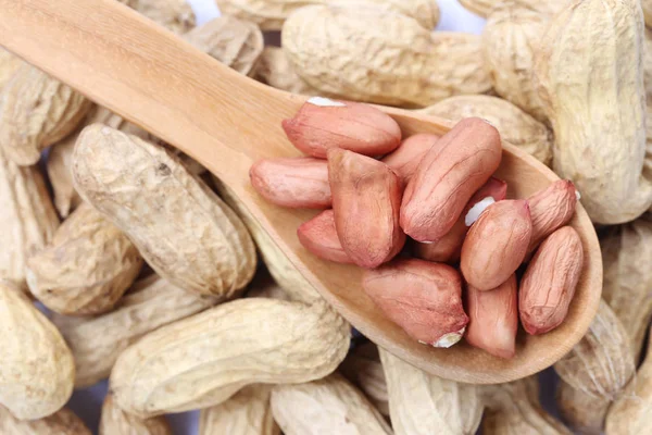 Peanuts on a wooden spoon. — Stock Photo, Image