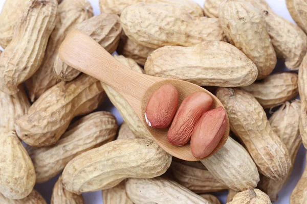 Peanuts on a wooden spoon. — Stock Photo, Image