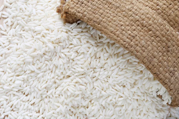 Brown hemp sack and organic white rice, glutinous rice or sticky — Stock Photo, Image