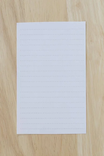 White paper blank or note paper on the brown wooden floor. — Stock Photo, Image