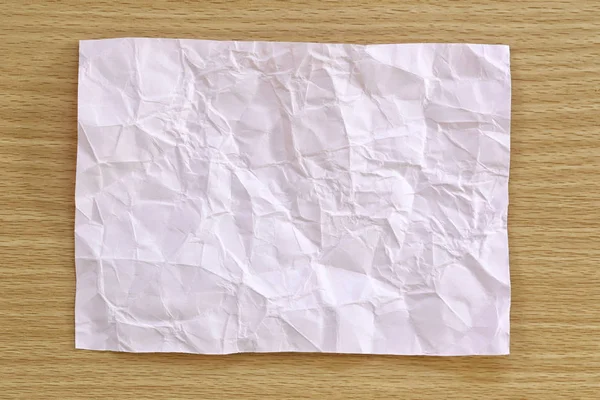 Pink notepad paper crumpled of empty and copy space on wooden ba — Stock Photo, Image