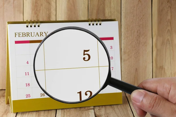 Zvětšovací sklo v rukou kalendáře můžete vypadat den pět mo — Stock fotografie