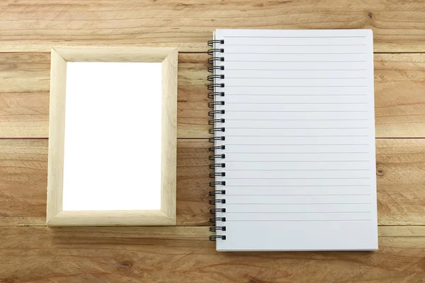 Wooden frame and empty notebook. — Stock Photo, Image