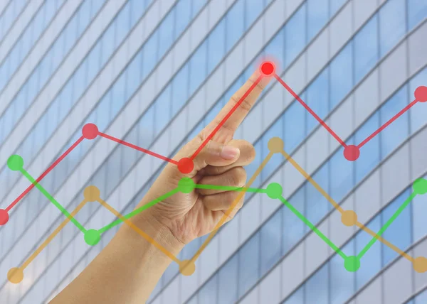 Hand of businessmen point to the highest point on the line graph in concept of business profits in the presentation.