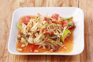 SOM TUM, Tayland yemekleri veya baharatlı papaya salatası ve ahşap masa arkasında Tayland 'da popülerdir..