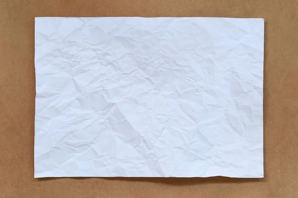 Boş Beyaz Kağıt Kahverengi Bir Arka Plan Üzerine Yerleştirilen — Stok fotoğraf