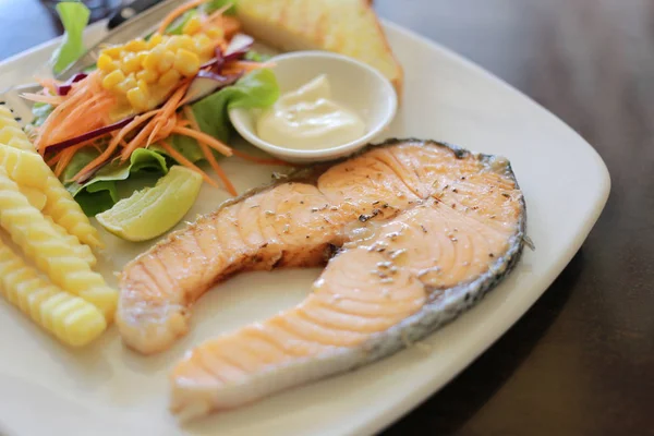 Salmon steak in a white plate. — Stock Photo, Image