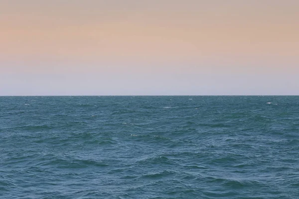 Blauwe zee en oranje hemelachtergrond. — Stockfoto