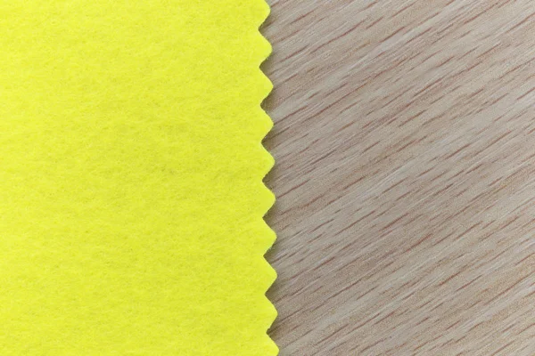 Yellow fabric on brown wooden and have copy space. — Stock Photo, Image