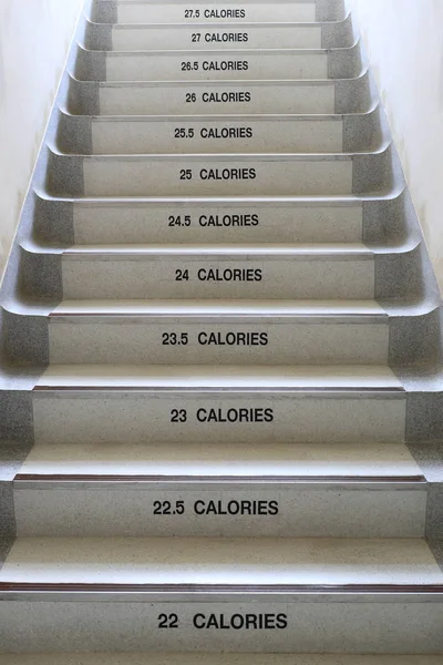 Walking stairs with ideas for fitness and energy saving. — Stock Photo, Image