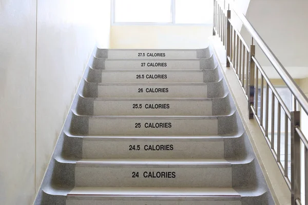 Walking stairs with ideas for fitness and energy saving. — Stock Photo, Image