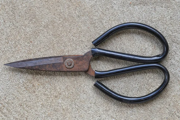 Old steel scissors placed on a concrete floor. — Stock Photo, Image