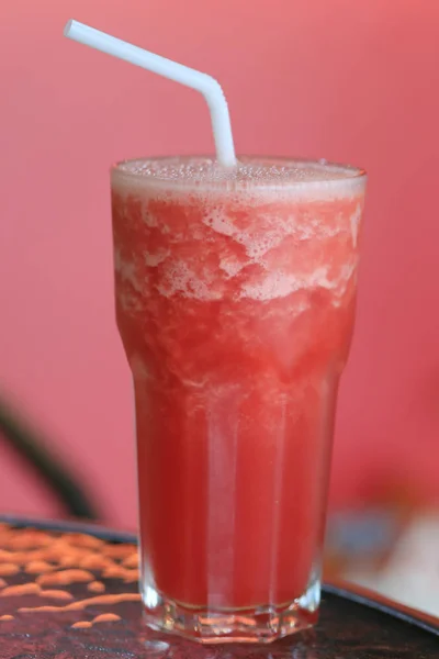 Watermelon smoothie in a glass and have white tube. — Stock Photo, Image