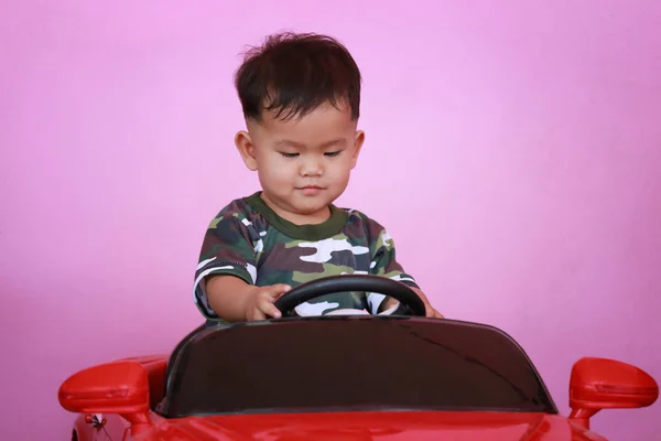 Asian Boy Driving Toy Car Have Pink Wall Background — Stock Photo, Image