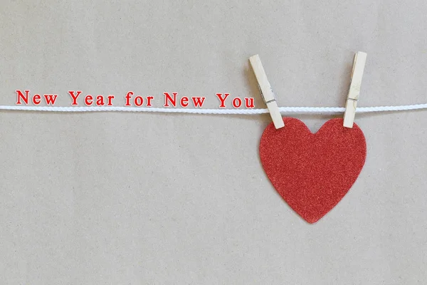 Red heart hanging on a rope and have New year for New you text. — Stock Photo, Image