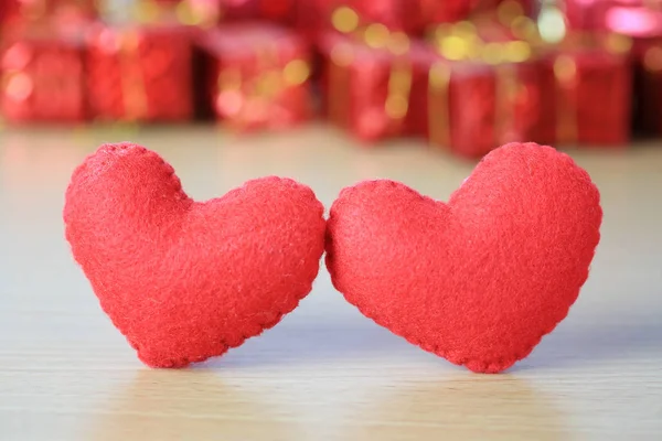 Red heart placed on a wooden floor on red gift box of blur backg — Stock Photo, Image