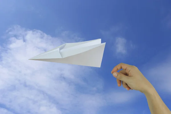 Elinde bir kağıt uçak üzerinde mavi gökyüzü backgrou atma işadamı — Stok fotoğraf