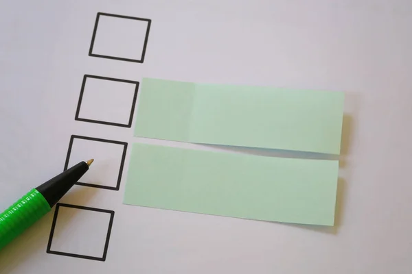 Green pen pointing empty checkbox and have blank paper note.