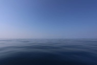 Smooth sea and blue sky in daytime with Clear air.