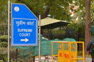 Blue NDMC board pointing towards the Supreme Court of India complex in Patel Marg, central part of Lutyen's Delhi. The Supreme court is the most revered and highest court of justice in the country clipart