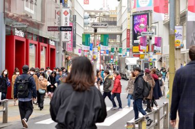 people walking through the city streets in Tokyo