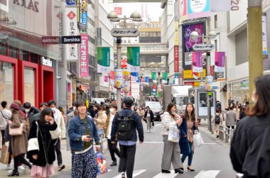 people walking through the city streets in Tokyo