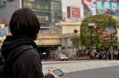 people walking through the city streets in Tokyo
