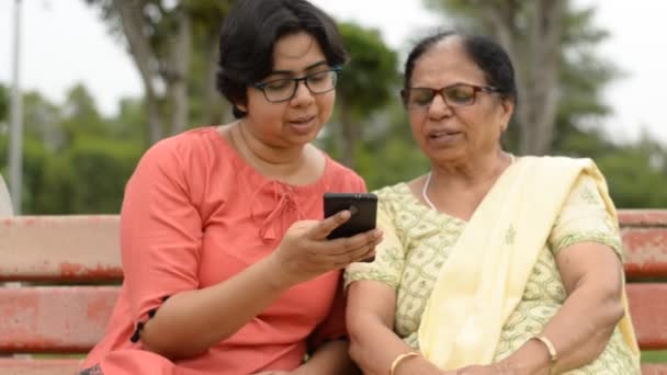 Women Reading Passing Phone — Video Stock