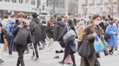 masked people in shibuya crossing