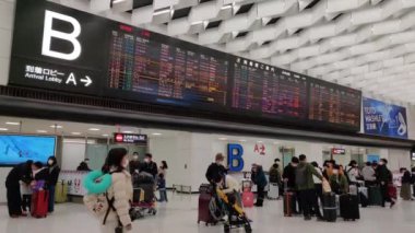 pan shot people waiting at departure narita airport