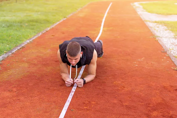 Man planking on the race track — Stock Photo, Image