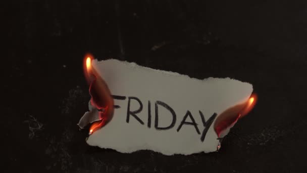 The paper with the word Friday burns, smoke and turns into ashes. Black backroung — Stockvideo