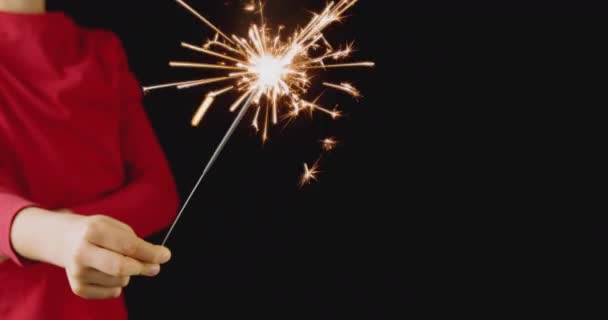 4k resolution of a kid holding Christmas party sparkler Christmas and New Year Celebration — Stock Video