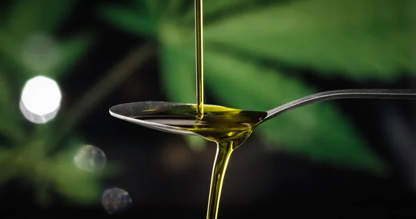 CBD hemp oil dropping on spoon — Stock Photo, Image