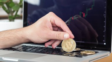 man playing with Bitcoin coins