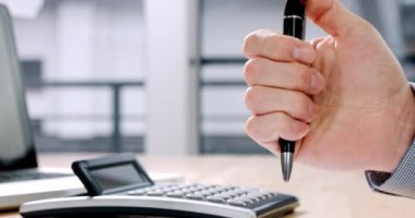 Stressed businessman clicking on pen