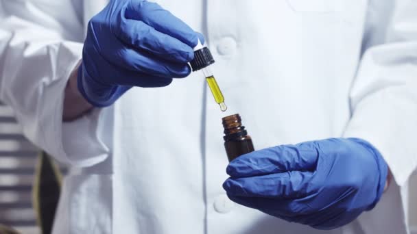 Scientist examining cannabis oil — Stock Video