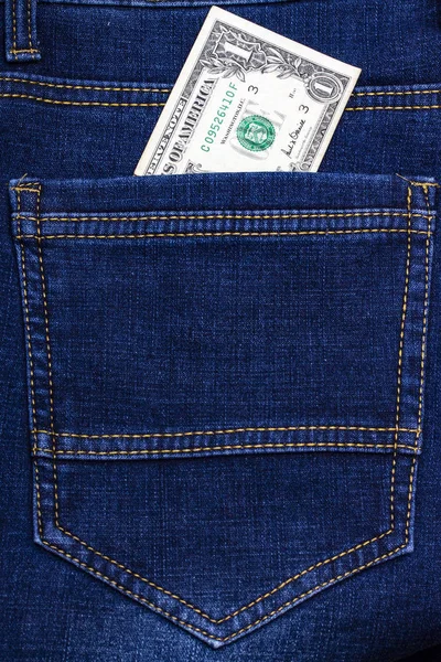 蓝色牛仔裤口袋里的一美元钞票 免版税图库照片