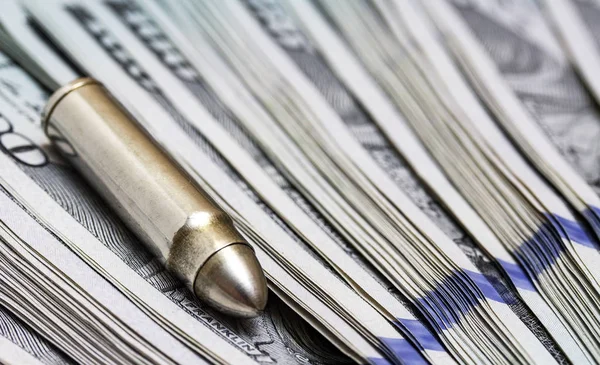 Ammunition from the gun on money bills — Stock Photo, Image