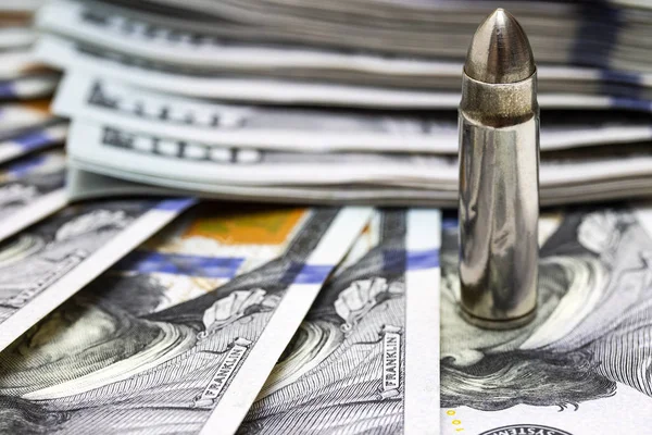 One bullet macro close up on american dollars background — Stock Photo, Image