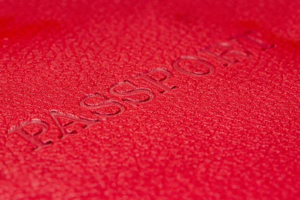 Red passport cover with letters on it