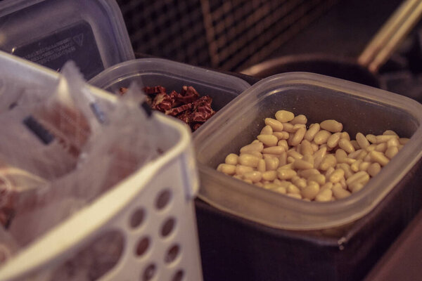 Tupperware with tea, pine nuts and cookies prepare in a kitchen in Seoul South Korea