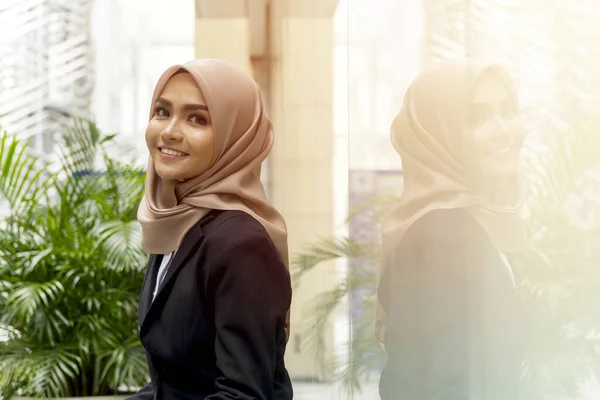 Business Lifestyle, Cute Malay Woman wearing hijab outdoor using laptop sitting on the bench