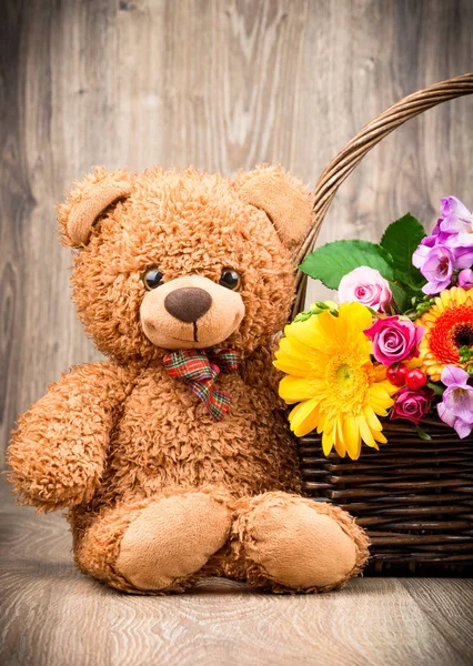 Bunch of flowers and a teddy bear — Stock Photo, Image