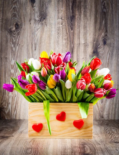 Flowers in the box on wooden background — Stock Photo, Image