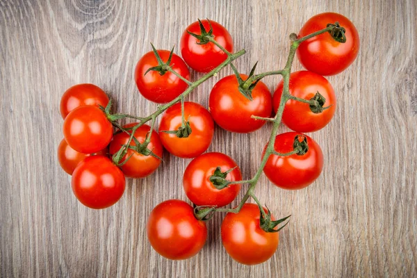 Cherry tomatoes on the wooden bacground — Stock Photo, Image
