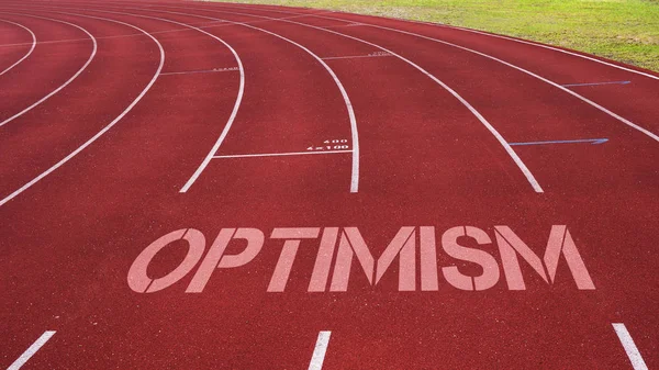 Cita motivacional escrita en la pista de atletismo: optimismo — Foto de Stock