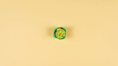 Sarı arka planda renkli kek dansı. Fırın kavramı 