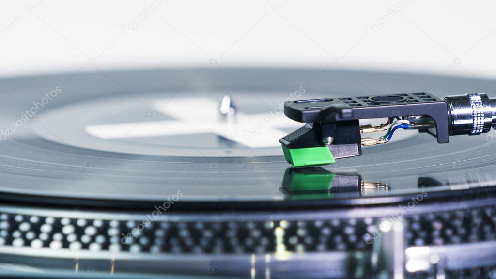 Close-up of modern turntable vinyl record player with music plate. Needle on a vinyl record. Concept of sound technology audio equipment