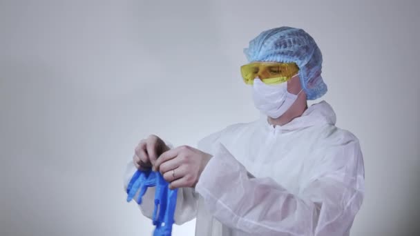 Close Young Male Doctor Protective Suit Putting Surgical Gloves Concept — Stock Video